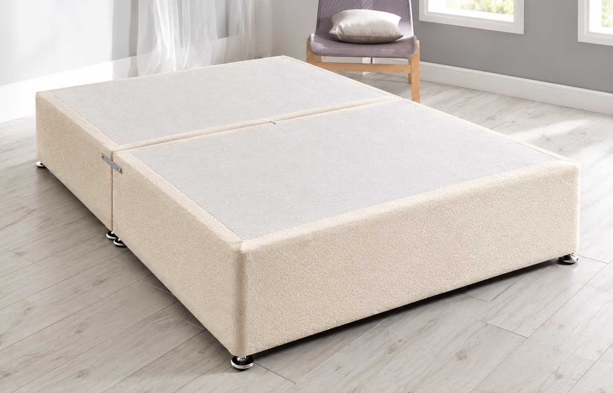 Luxury cream velvet divan bed with two storage drawers and padded vertical panel headboard.